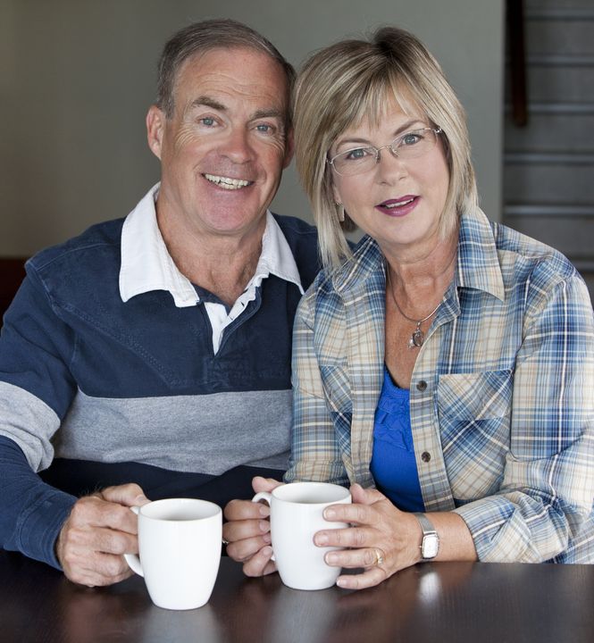 15717164 - happy senior couple is having coffee together indoors adult-eye-exam-atlantic-vision-center-wilmington-nc-eye-care